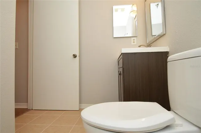 a view of a lake with a yard and large trees