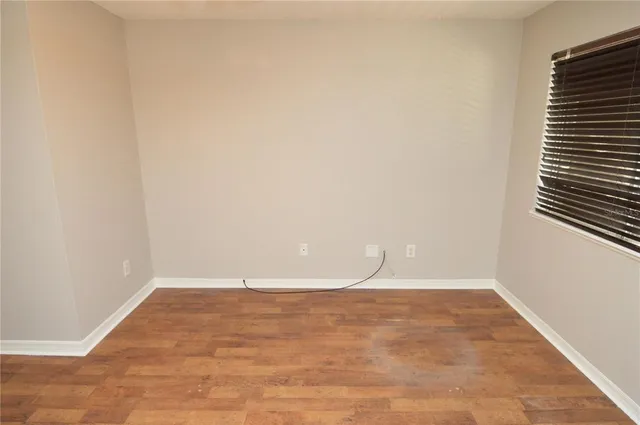 a view of a house with a big yard and a large tree