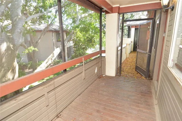 a view of a patio with a table and chairs under an umbrella