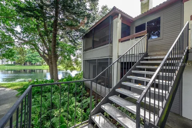 a view of a lake with a floor to ceiling window next to a lake