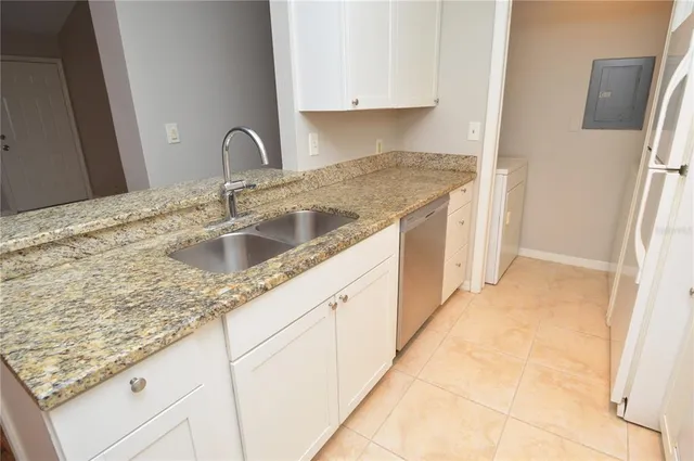 a view of a kitchen with a sink and a fireplace