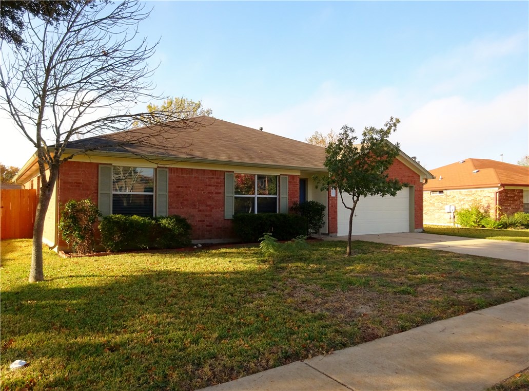 1303 Crossvine Way Pflugerville, TX 78660 - Photo 1 of 1 a front view of a house with yard and green space