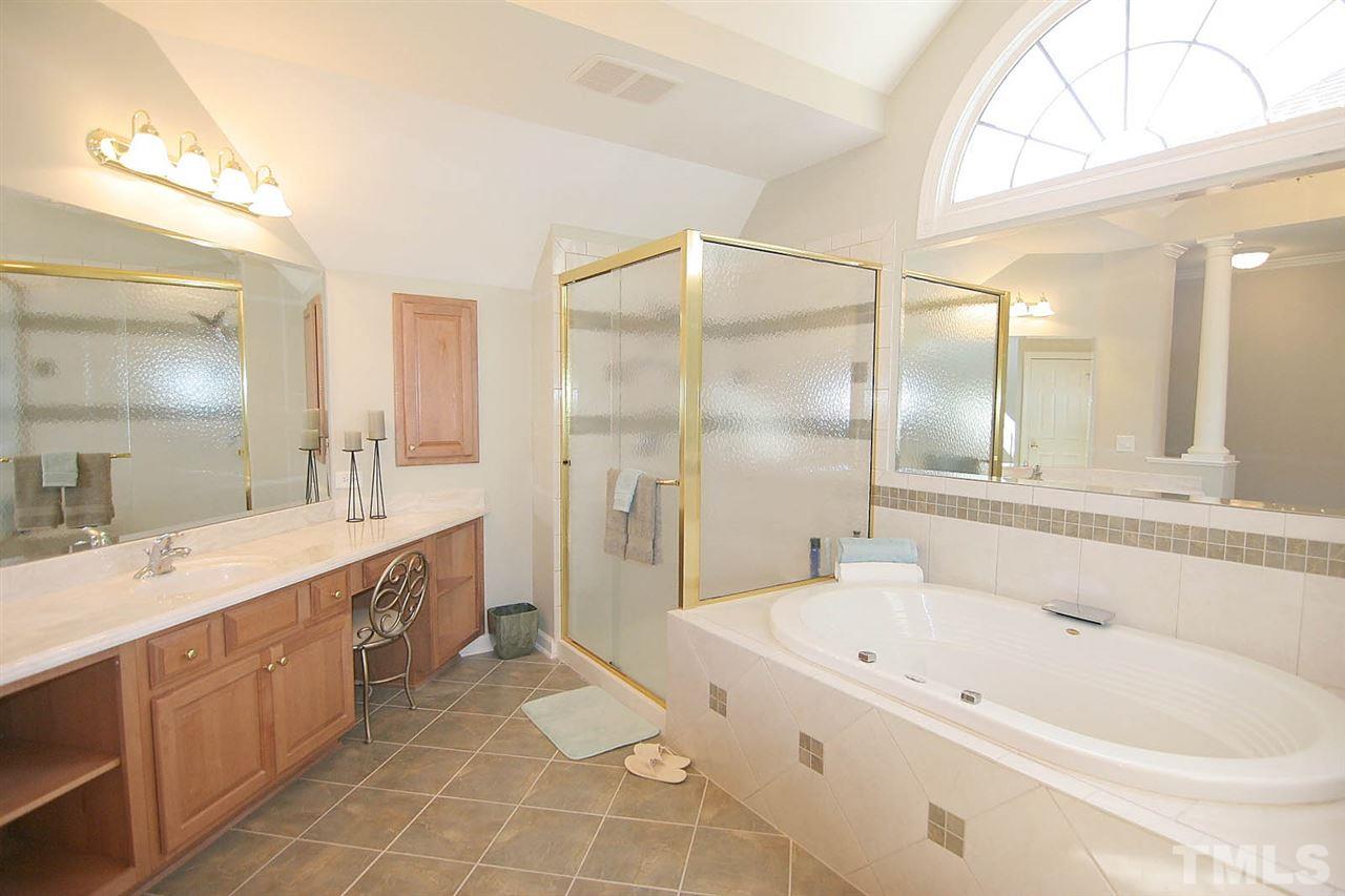 11833 Lowery Ridge Drive Raleigh, NC 27614 - Photo 12 of 25 Master Bath has his/her vanities, his/her walk in closets, jacuzzi tub and tiled shower. Brass fixtures can be easily updated by new owners should they choose.