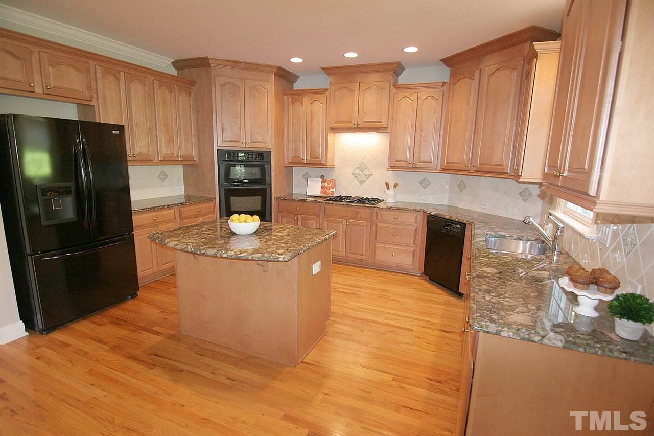 11833 Lowery Ridge Drive Raleigh, NC 27614 - Photo 9 of 25 Spacious Kitchen with granite and custom backsplash. Appliances are barely used and look new. Gas cooktop.