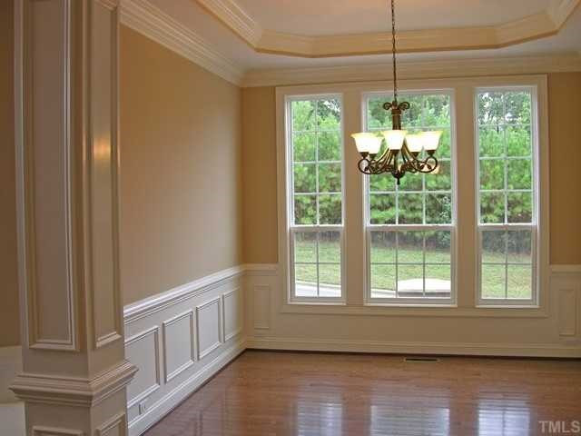 3903 Morvan Way Raleigh, NC 27612 - Photo 4 of 12 Separate dining room is elegant with trey ceiling, chair rail, & panel molding. View of hardwood trees at the side of the home. Kitchen is located to the right and the 2 story foyer & study to the left. Dining Room