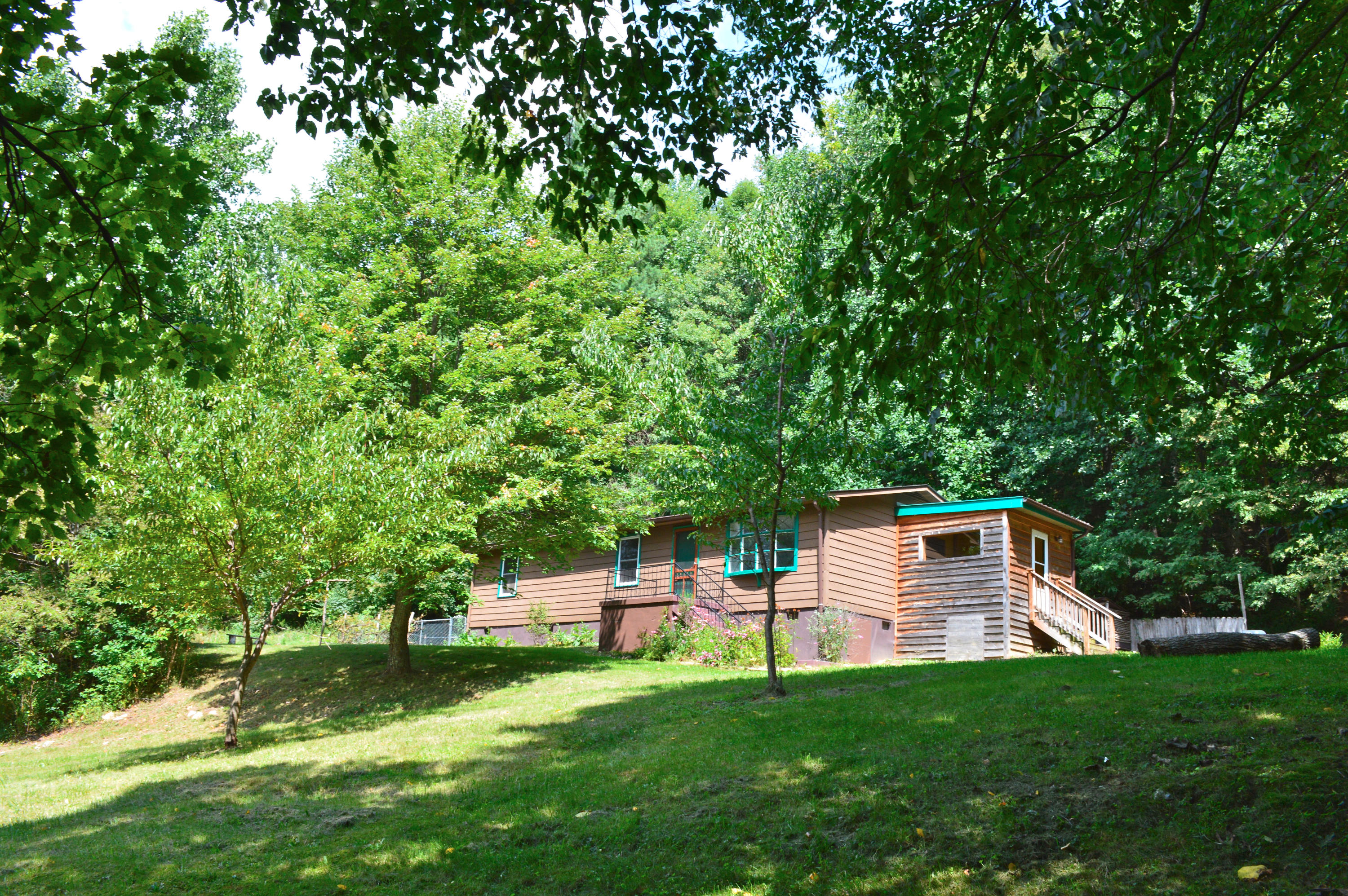 5075 Alum Ridge Road Northwest Riner, VA 24149 - Photo 19 of 28 a backyard of a house with table and chairs