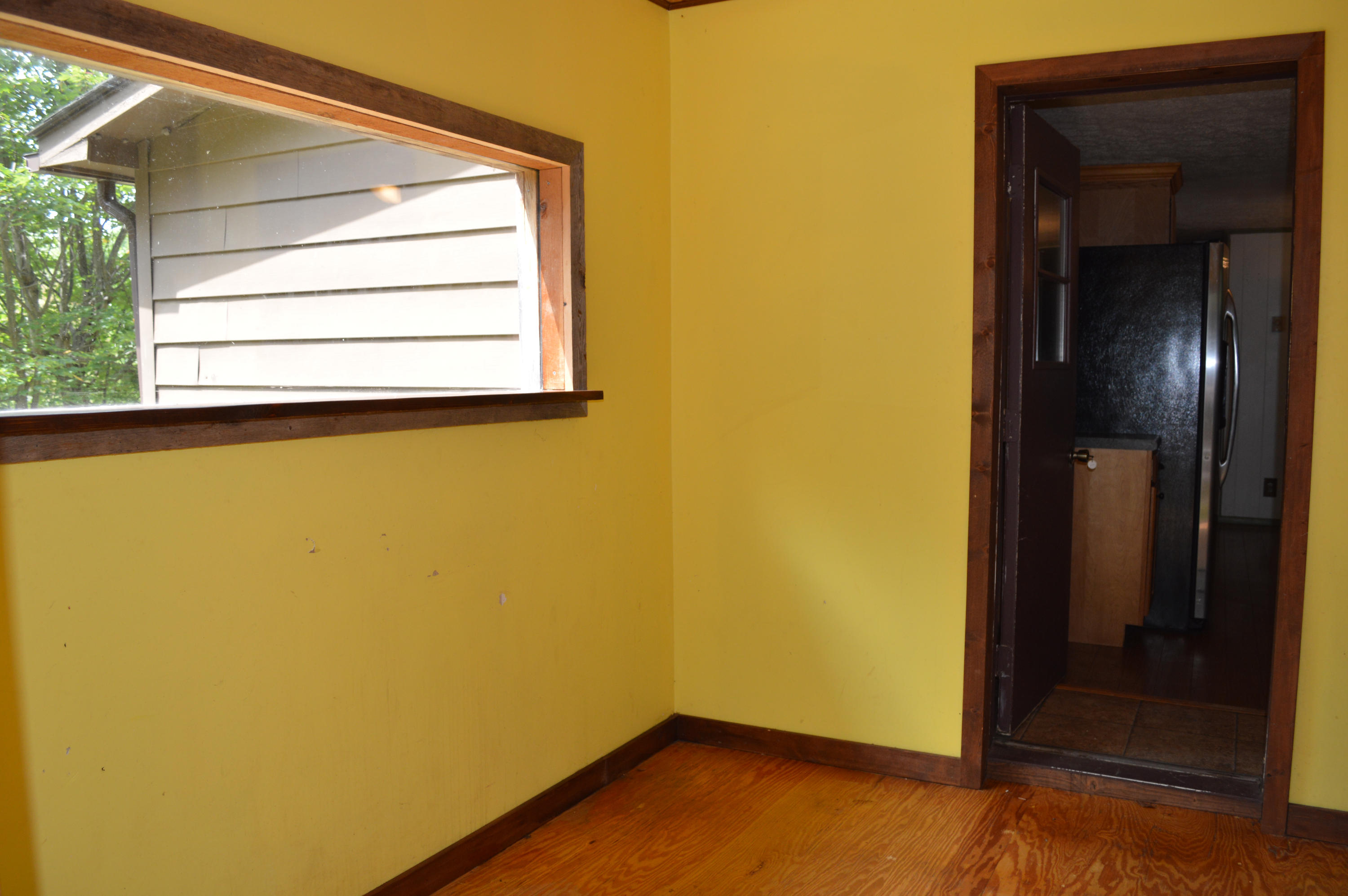 5075 Alum Ridge Road Northwest Riner, VA 24149 - Photo 3 of 28 a view of a small space with wooden floor and a window