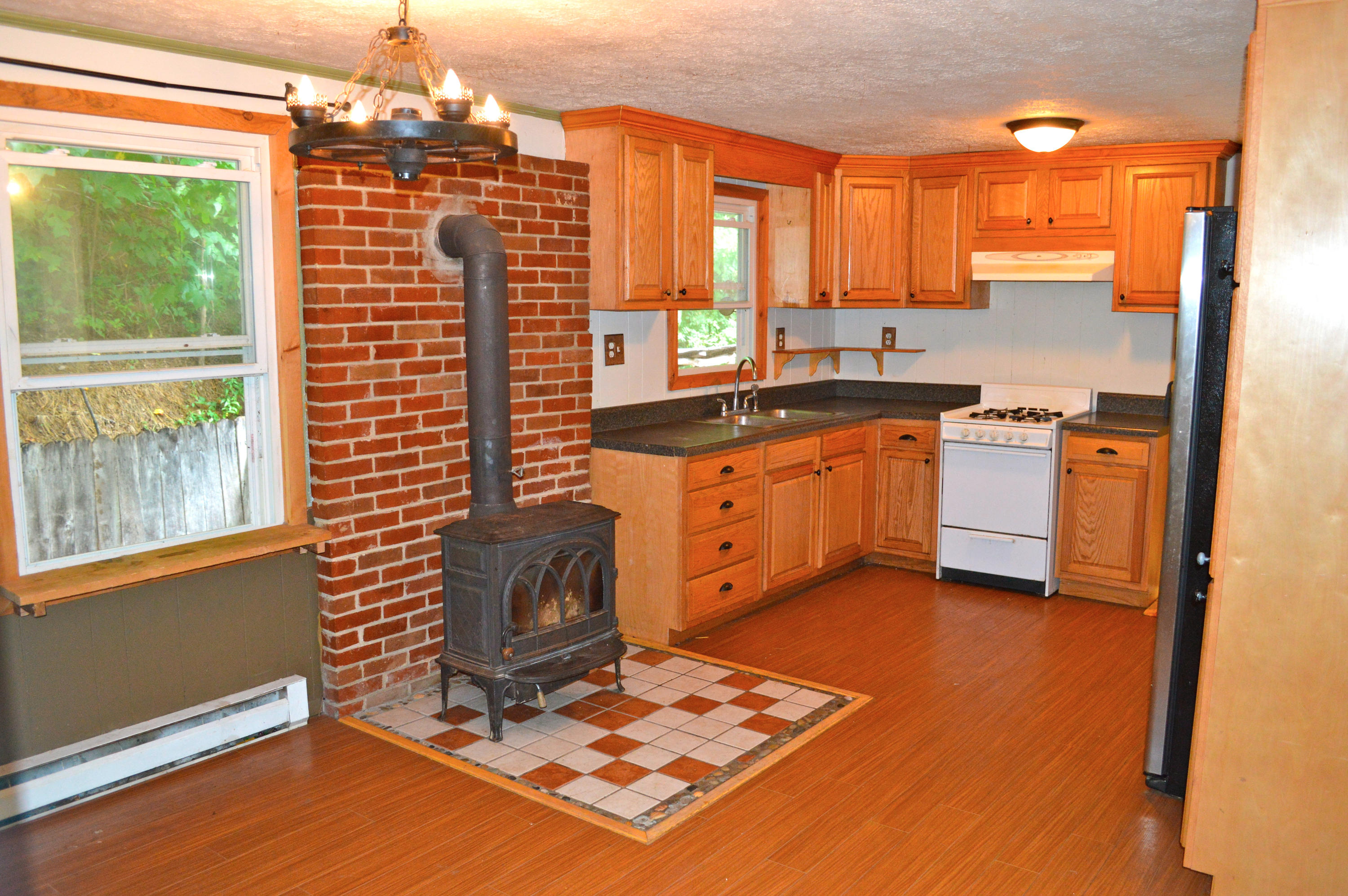 5075 Alum Ridge Road Northwest Riner, VA 24149 - Photo 6 of 28 a kitchen with stainless steel appliances granite countertop a stove a sink and a refrigerator