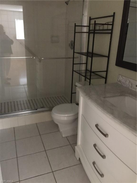 5651 Rattlesnake Hammock Road, Unit C108 Naples, FL 34113 - Photo 13 of 14 a bathroom with a toilet and a shower