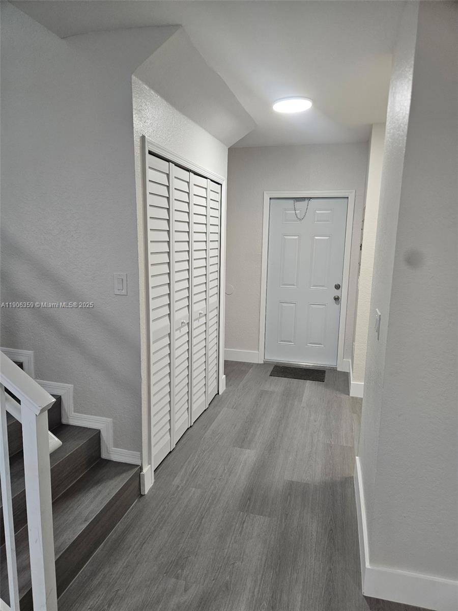 6752 Northwest 182nd Street, Unit 101 Hialeah, FL 33015 - Photo 12 of 23 wooden floor in an empty room