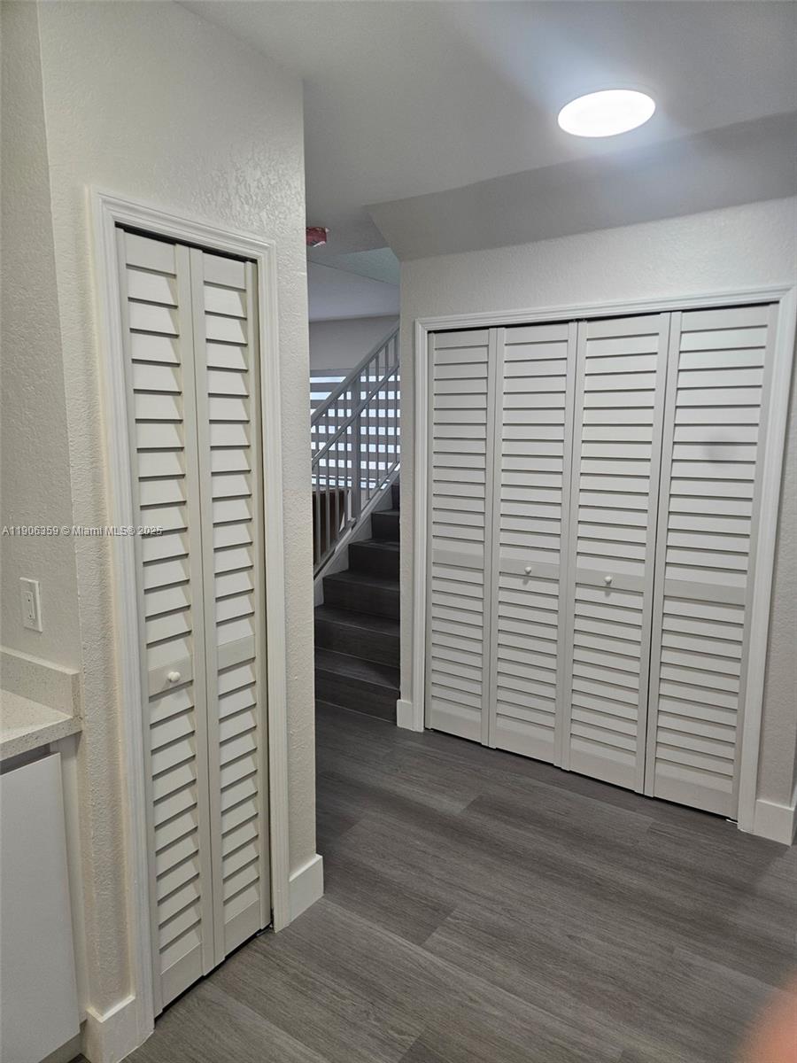 6752 Northwest 182nd Street, Unit 101 Hialeah, FL 33015 - Photo 13 of 23 wooden floor in an empty room and a window