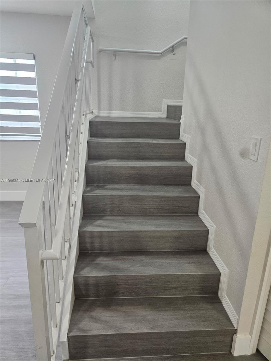 6752 Northwest 182nd Street, Unit 101 Hialeah, FL 33015 - Photo 15 of 23 a view of staircase with white walls