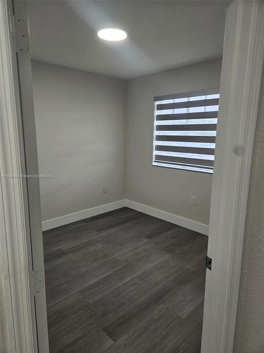 6752 Northwest 182nd Street, Unit 101 Hialeah, FL 33015 - Photo 16 of 23 a view of empty room with wooden floor