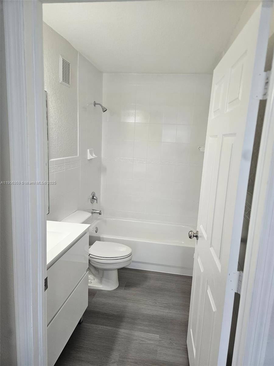 6752 Northwest 182nd Street, Unit 101 Hialeah, FL 33015 - Photo 17 of 23 a bathroom with a toilet a sink and bathtub