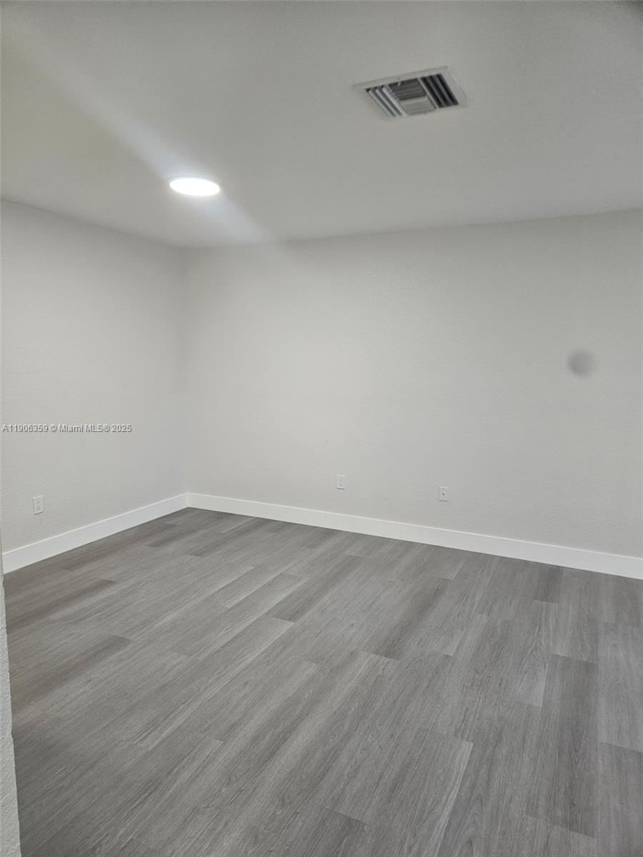 6752 Northwest 182nd Street, Unit 101 Hialeah, FL 33015 - Photo 18 of 23 a view of an empty room