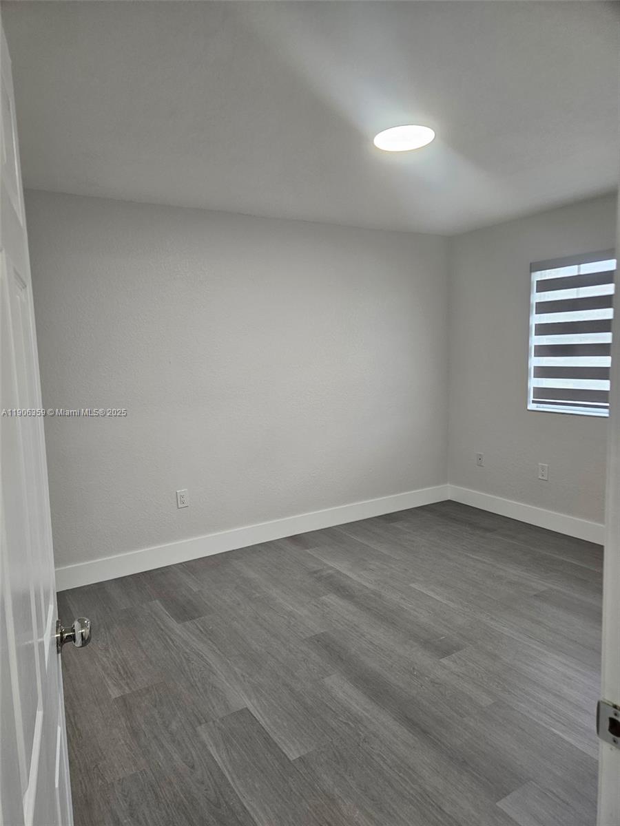 6752 Northwest 182nd Street, Unit 101 Hialeah, FL 33015 - Photo 20 of 23 a view of an empty room and a window