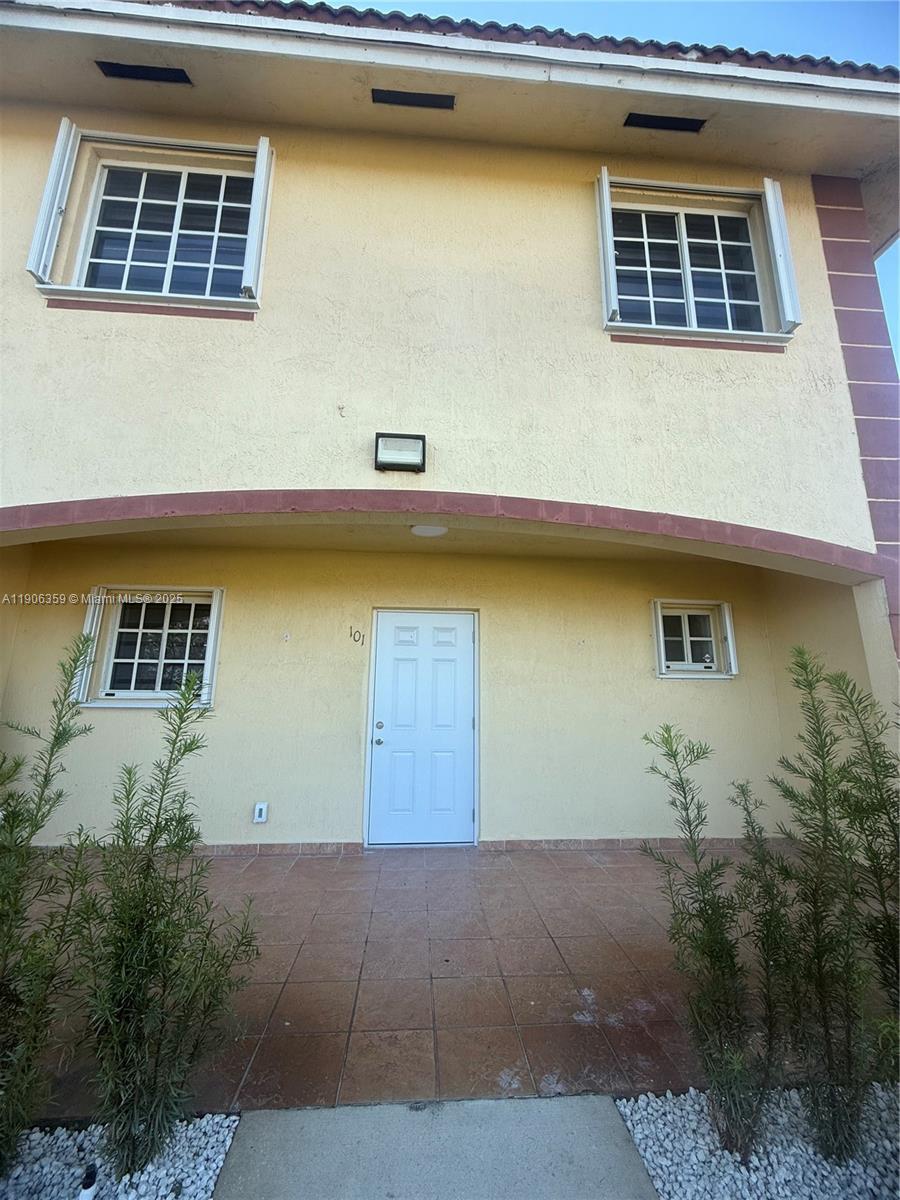 6752 Northwest 182nd Street, Unit 101 Hialeah, FL 33015 - Photo 2 of 23 a front view of a house with lake