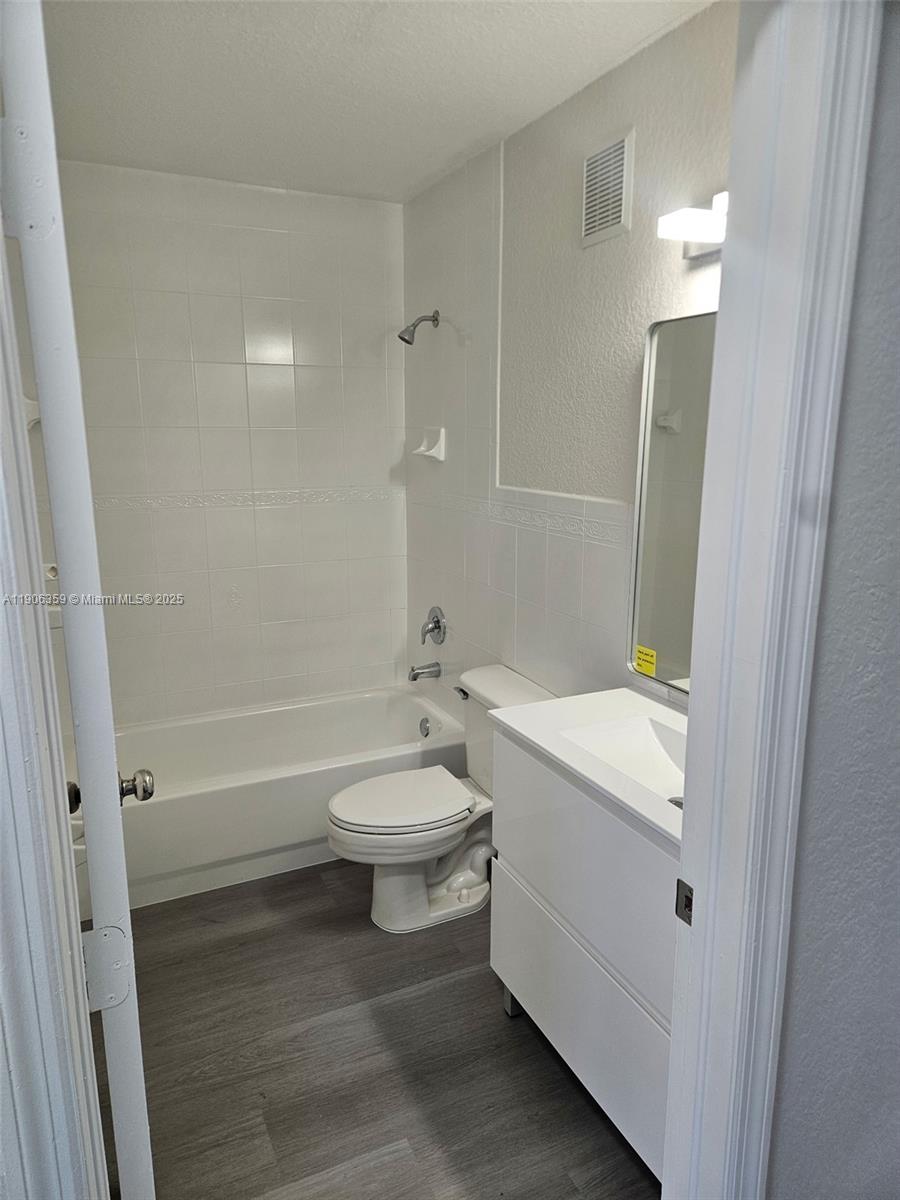 6752 Northwest 182nd Street, Unit 101 Hialeah, FL 33015 - Photo 21 of 23 a bathroom with a toilet sink and shower