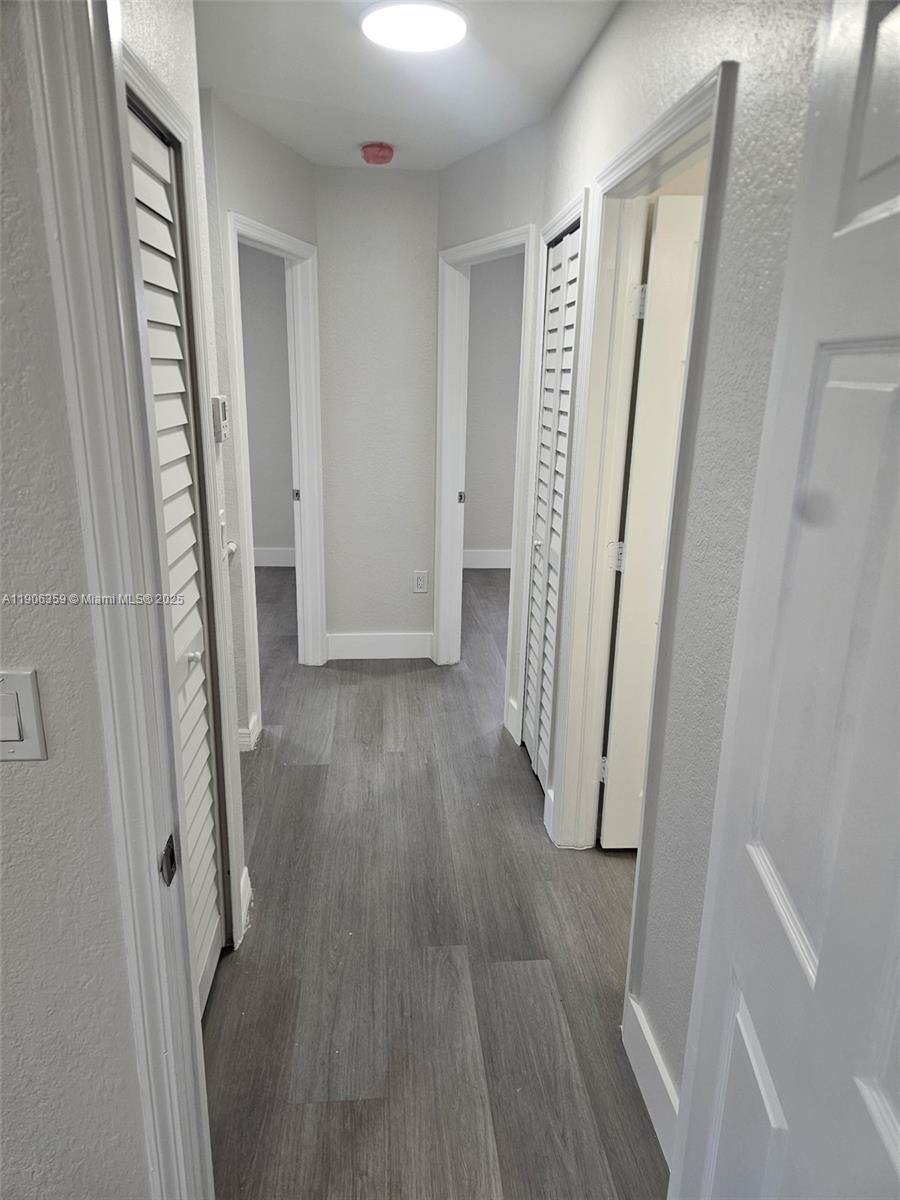 6752 Northwest 182nd Street, Unit 101 Hialeah, FL 33015 - Photo 22 of 23 wooden floor in a gallery
