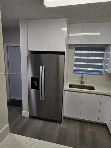 a kitchen with stainless steel appliances a refrigerator and a sink