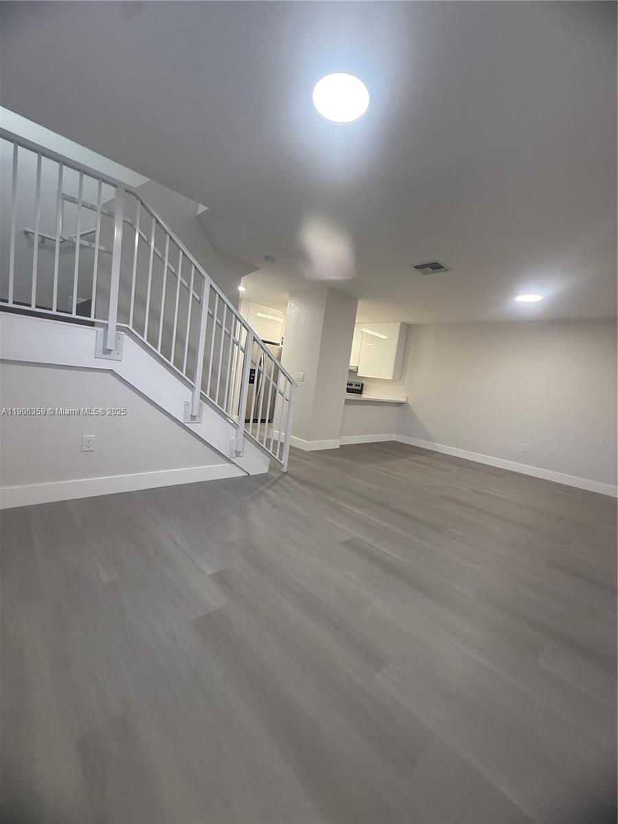 6752 Northwest 182nd Street, Unit 101 Hialeah, FL 33015 - Photo 8 of 23 a view of entryway with wooden floor