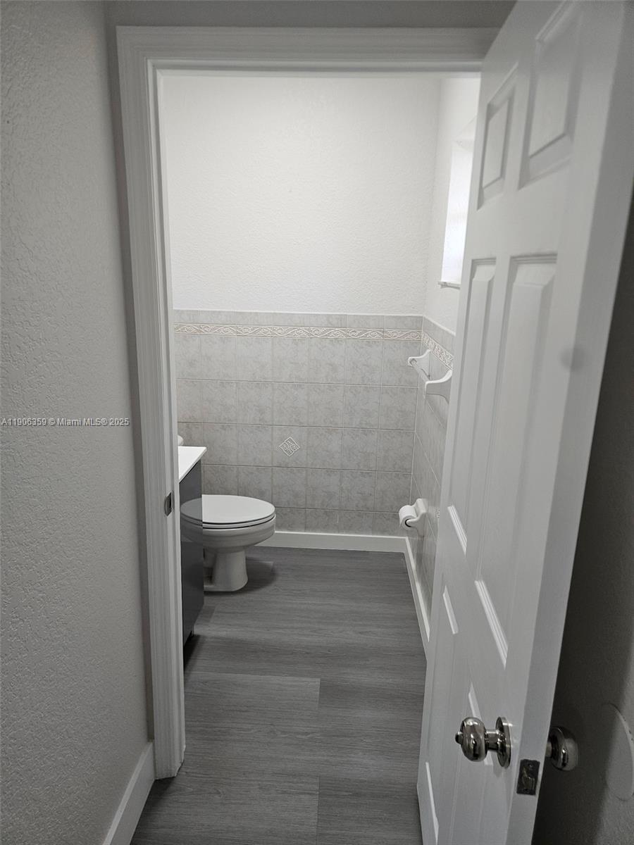 6752 Northwest 182nd Street, Unit 101 Hialeah, FL 33015 - Photo 10 of 23 a bathroom with a toilet and a shower