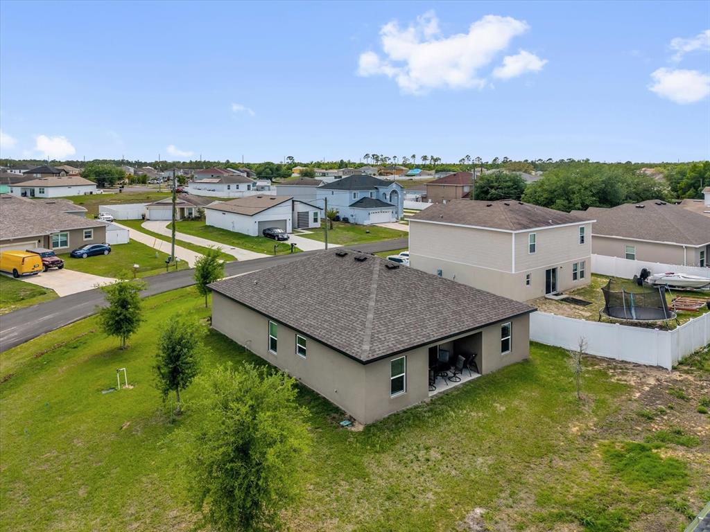 2134 Rio Grande Canyon Loop Poinciana, FL 34759 - Photo 20 of 22 an aerial view of a house with a garden and plants