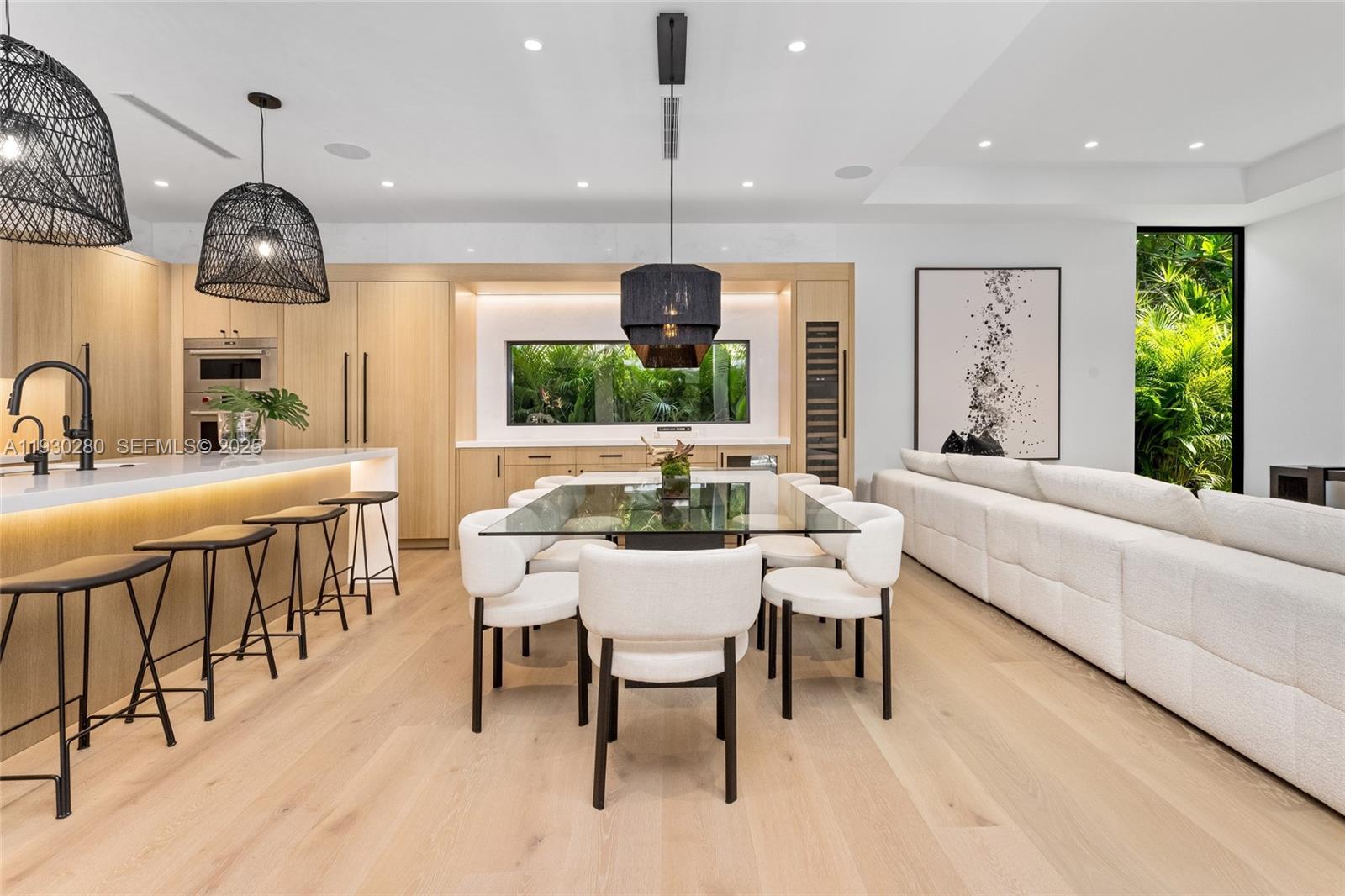 4024 Bonita Avenue Miami, FL 33133 - Photo 12 of 99 a dining room with furniture a chandelier and wooden floor
