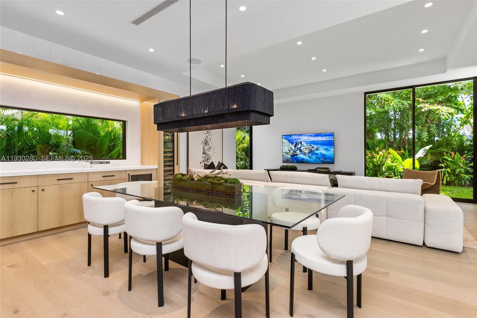 4024 Bonita Avenue Miami, FL 33133 - Photo 15 of 99 a dining room with furniture a large window and a fireplace