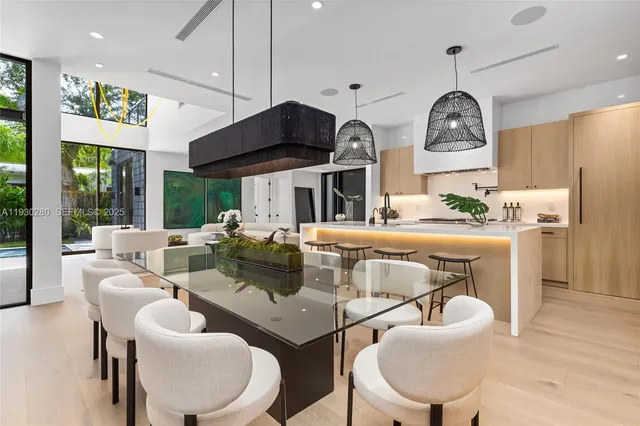 a living room with patio furniture and a potted plant