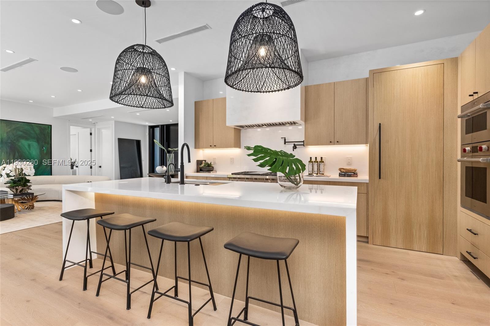 4024 Bonita Avenue Miami, FL 33133 - Photo 19 of 99 a kitchen with stainless steel appliances kitchen island granite countertop a table chairs and a chandelier