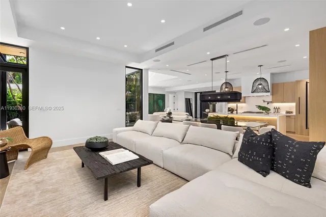 a spacious bedroom with a bed and a chandelier