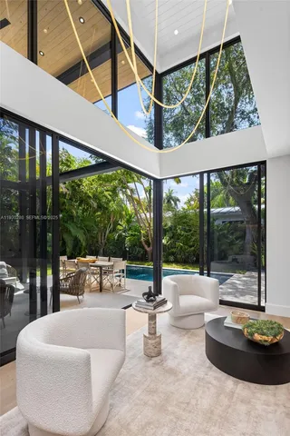 a bedroom with two beds and large window