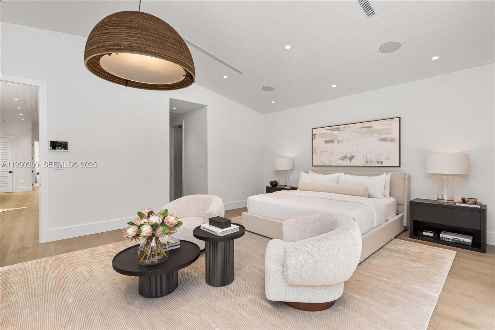 4024 Bonita Avenue Miami, FL 33133 - Photo 48 of 99 a spacious bedroom with a bed and a chandelier