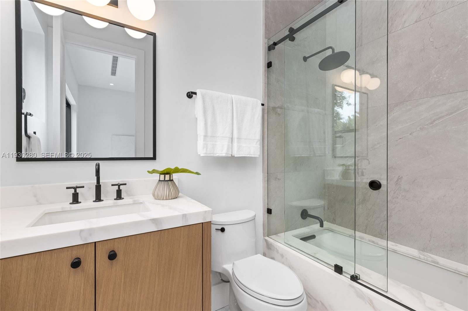 4024 Bonita Avenue Miami, FL 33133 - Photo 67 of 99 a bathroom with a sink a toilet and shower