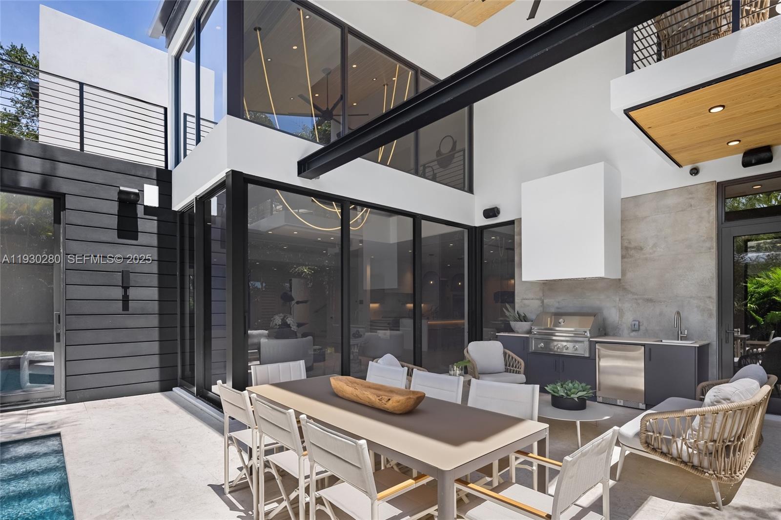 4024 Bonita Avenue Miami, FL 33133 - Photo 71 of 99 a outdoor space with patio the couches and a dining table with the view of the balcony