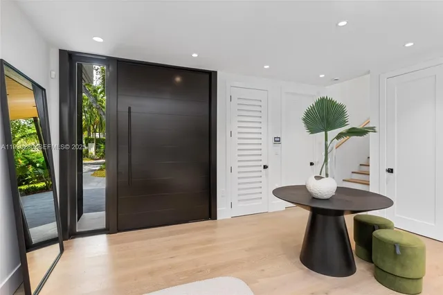 a kitchen with stainless steel appliances kitchen island granite countertop a table chairs and a chandelier