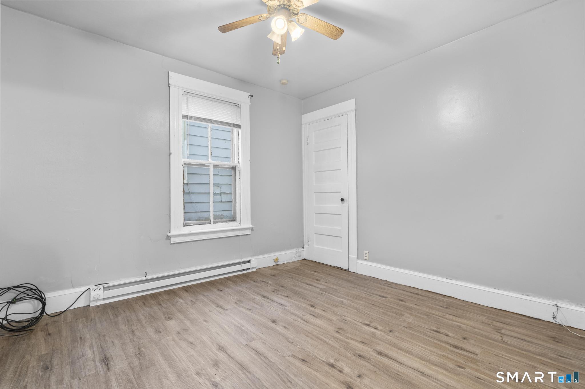 73 South Street Waterbury, CT 06706 - Photo 11 of 29 a view of an empty room with wooden floor and a window