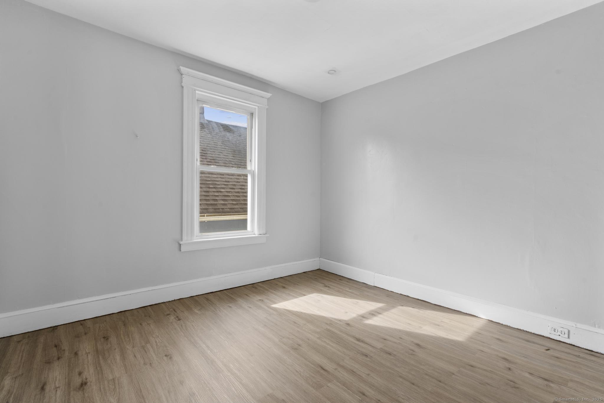 73 South Street Waterbury, CT 06706 - Photo 16 of 29 wooden floor in an empty room with a window