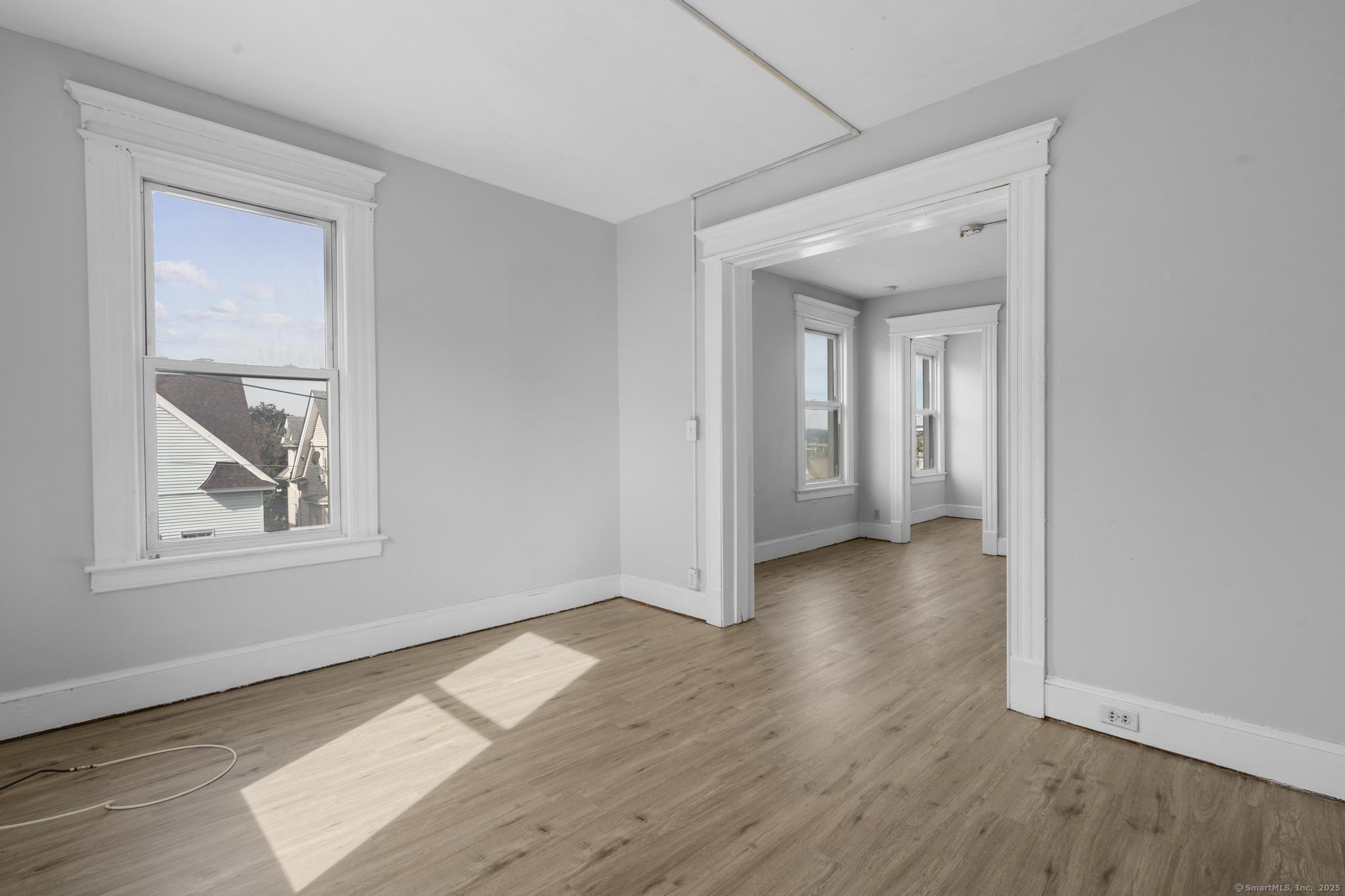 73 South Street Waterbury, CT 06706 - Photo 19 of 29 an empty room with wooden floor and a window
