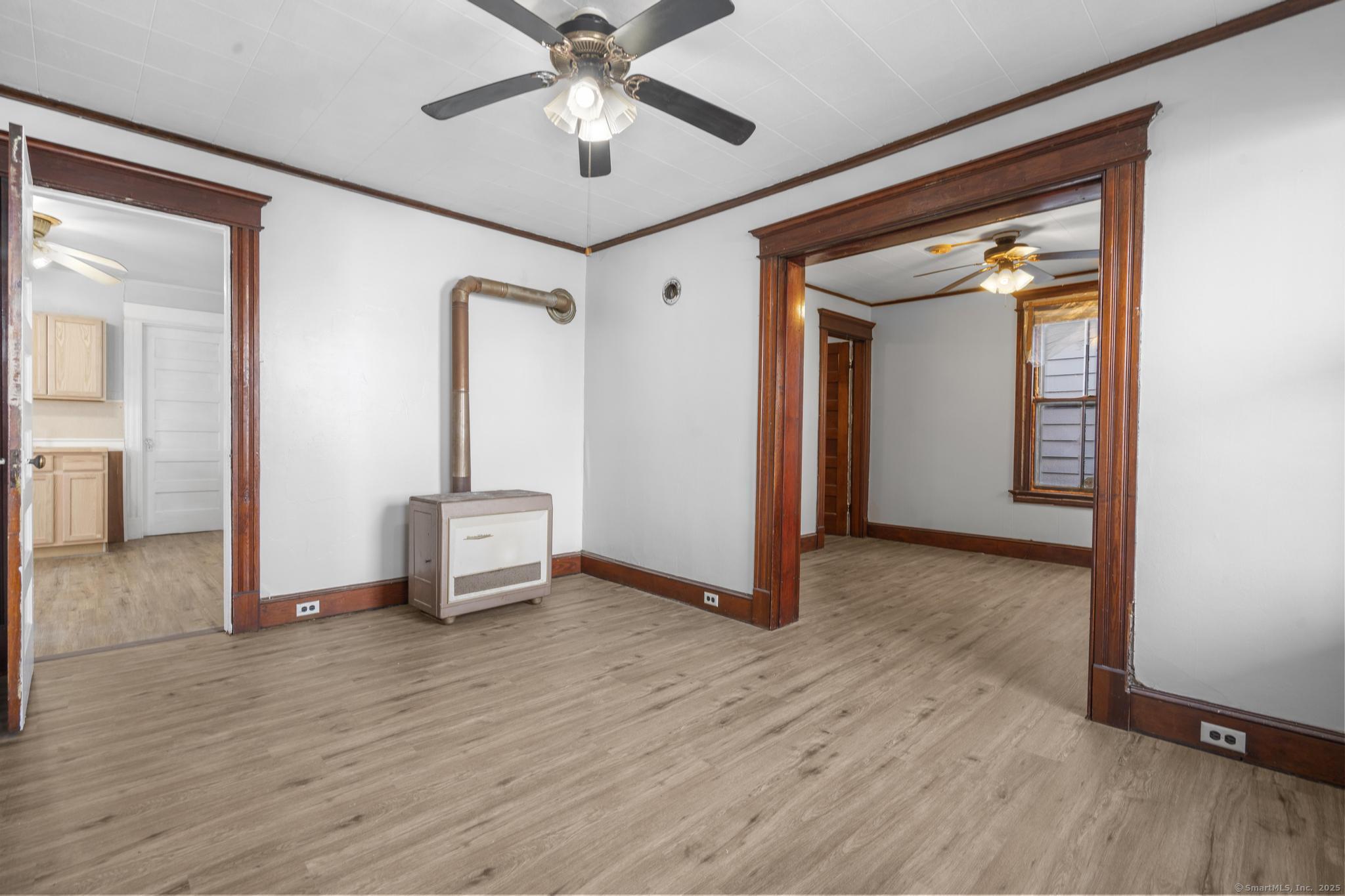 73 South Street Waterbury, CT 06706 - Photo 20 of 29 a view of a livingroom with wooden floor and a ceiling fan