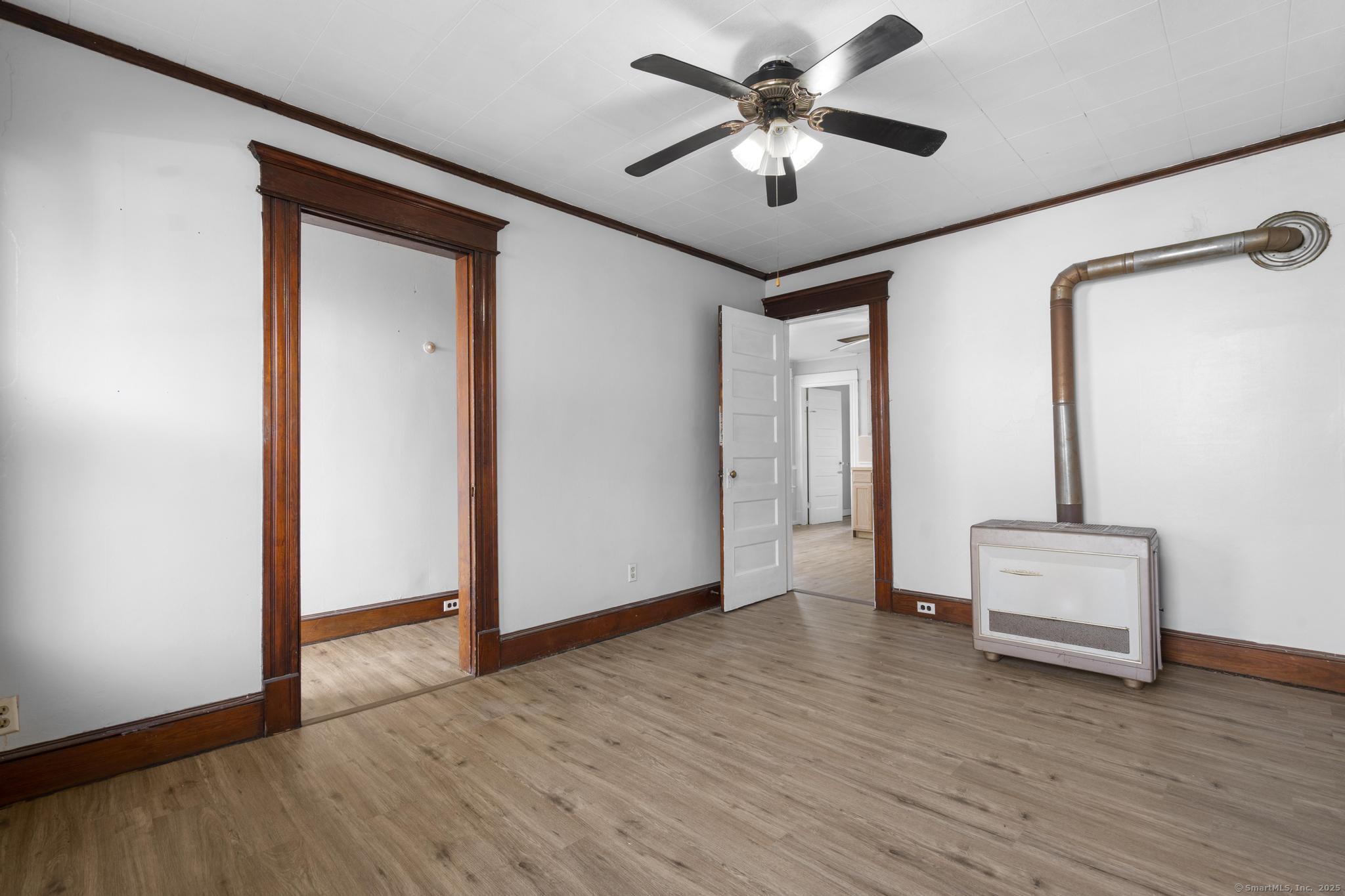 73 South Street Waterbury, CT 06706 - Photo 22 of 29 a view of an empty room with wooden floor and a ceiling fan