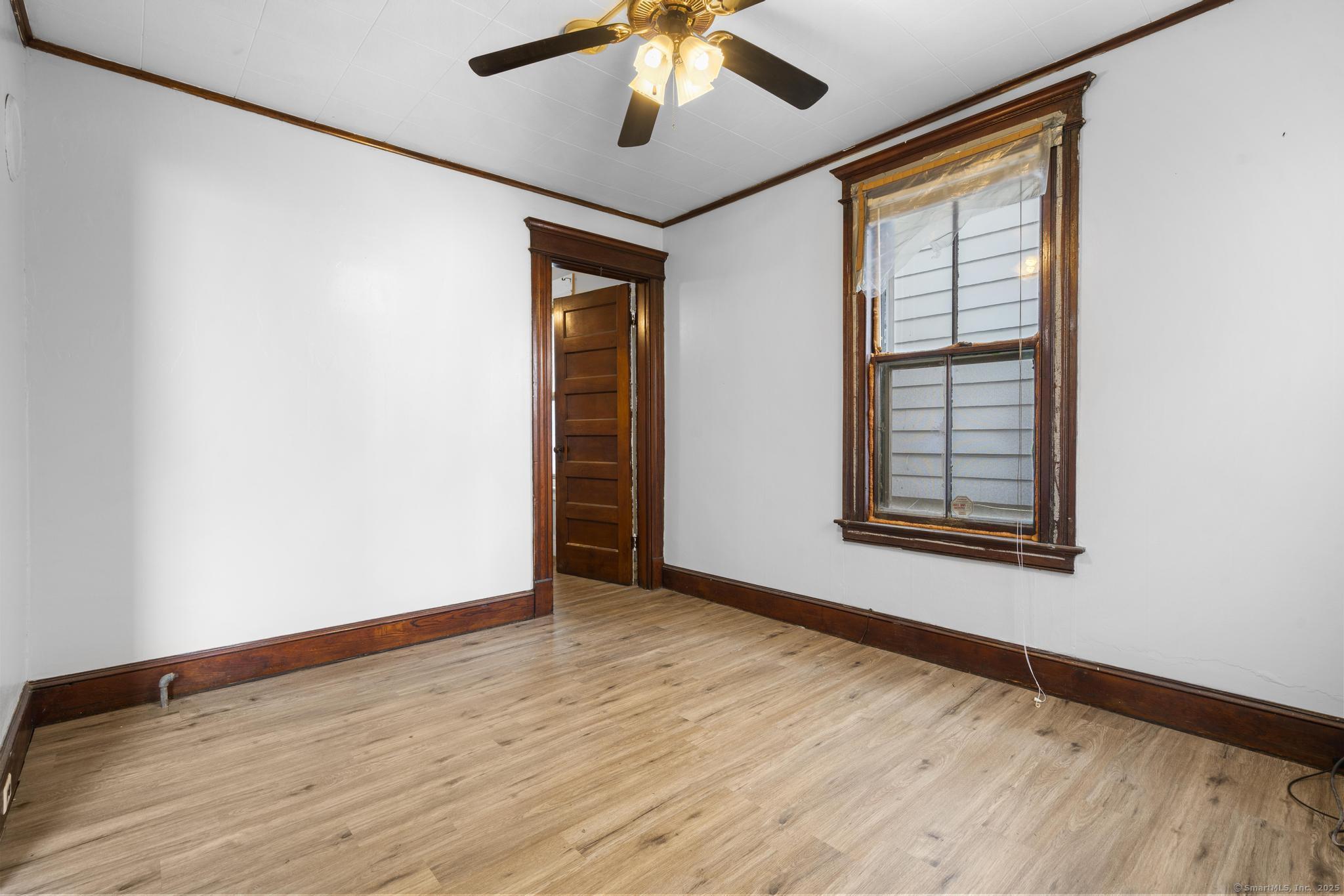 73 South Street Waterbury, CT 06706 - Photo 23 of 29 a view of an empty room with window and wooden floor