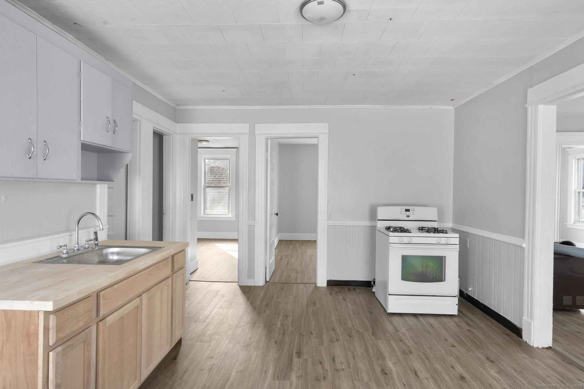 73 South Street Waterbury, CT 06706 - Photo 4 of 29 a kitchen with a sink cabinets and wooden floor