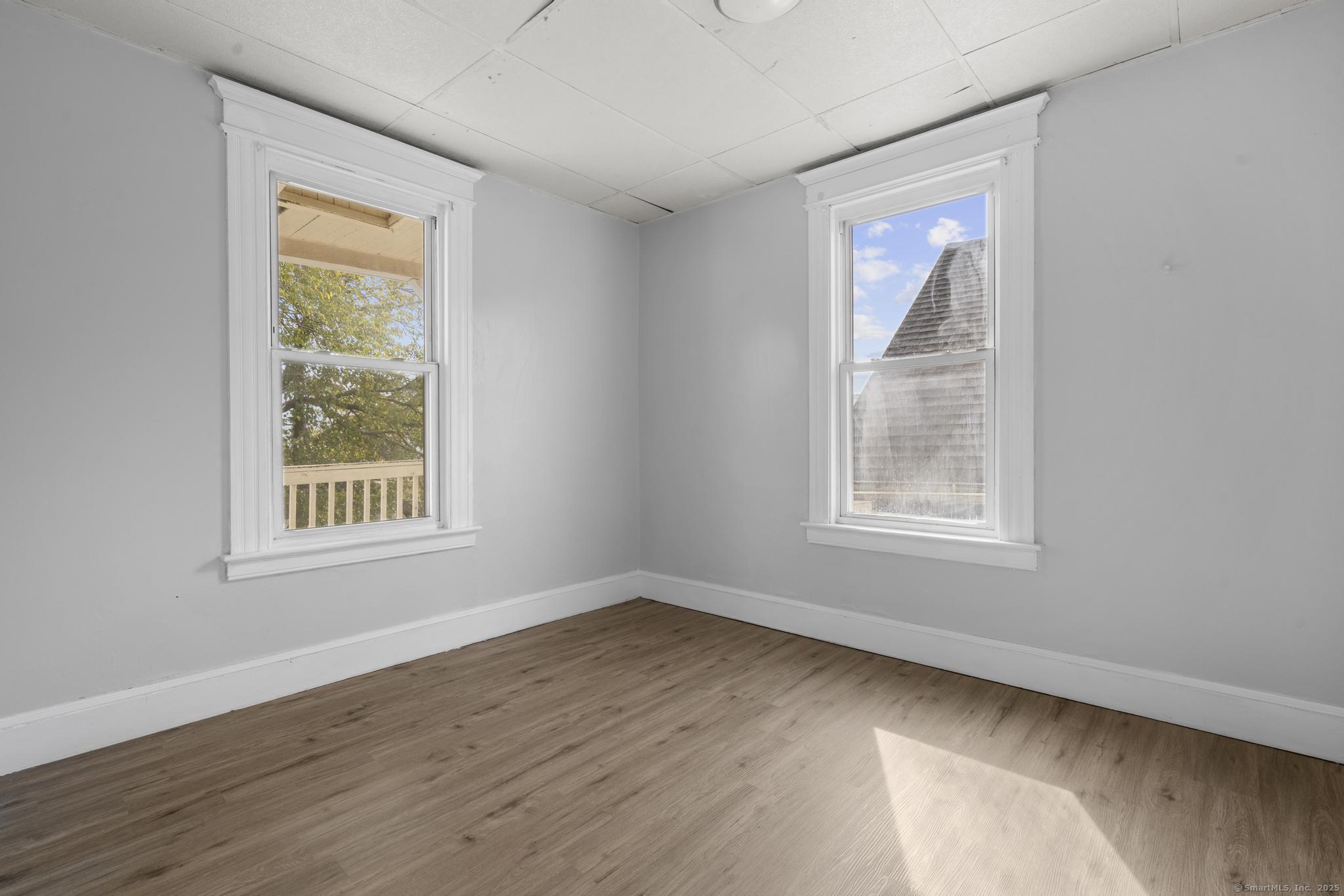 73 South Street Waterbury, CT 06706 - Photo 7 of 29 a view of an empty room with wooden floor and a window