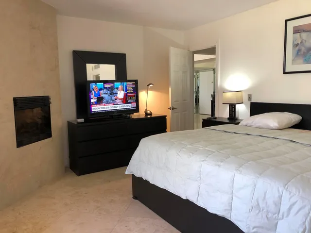 a bed sitting in a bedroom next to a lamp