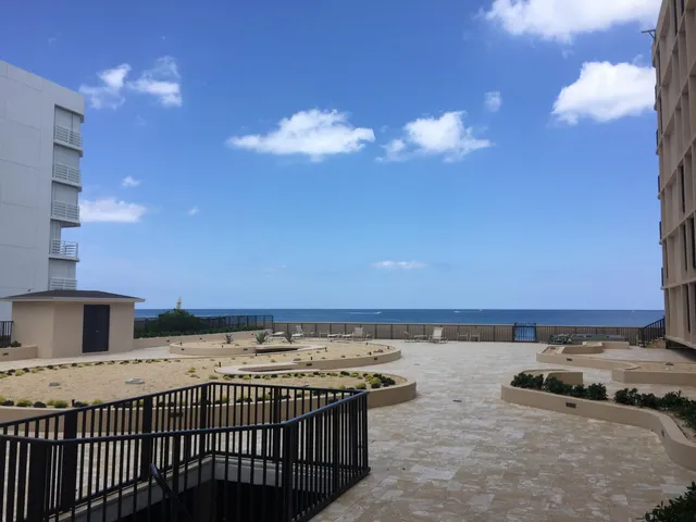 a view of kitchen with stainless steel appliances granite countertop a stove and a sink