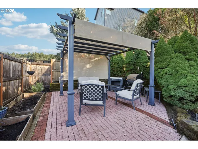 a view of a chairs and table in backyard of the house