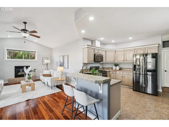 a kitchen with a sink stainless steel appliances and cabinets