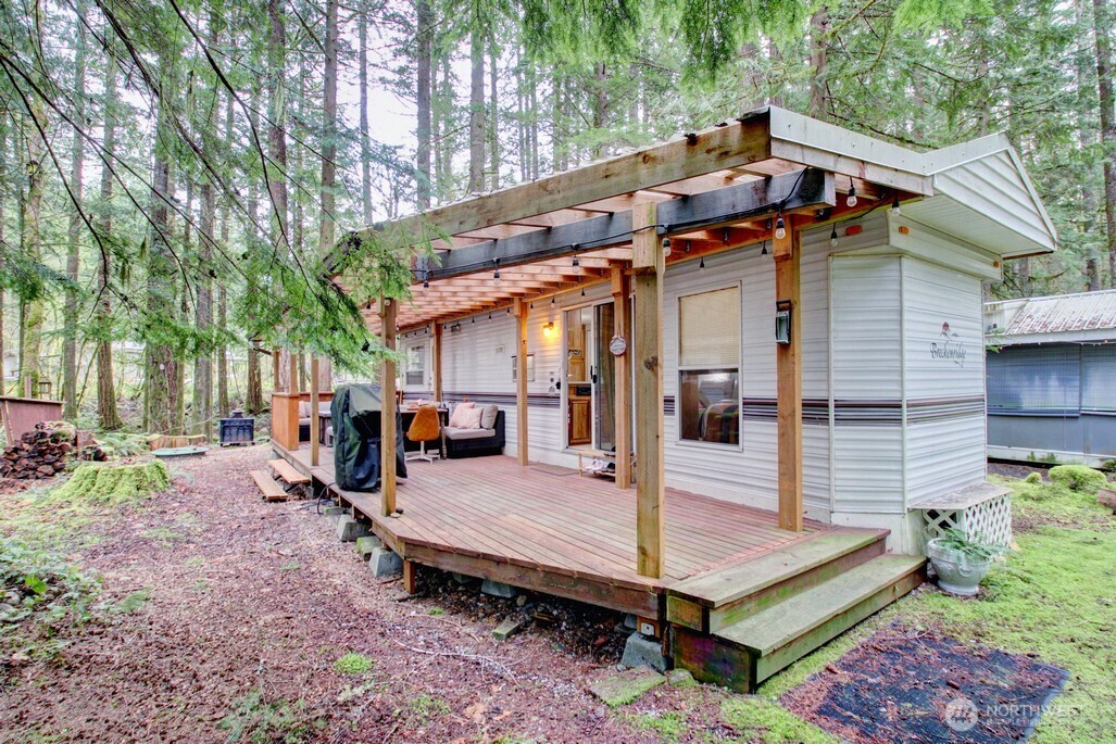 a view of a house with backyard and sitting area